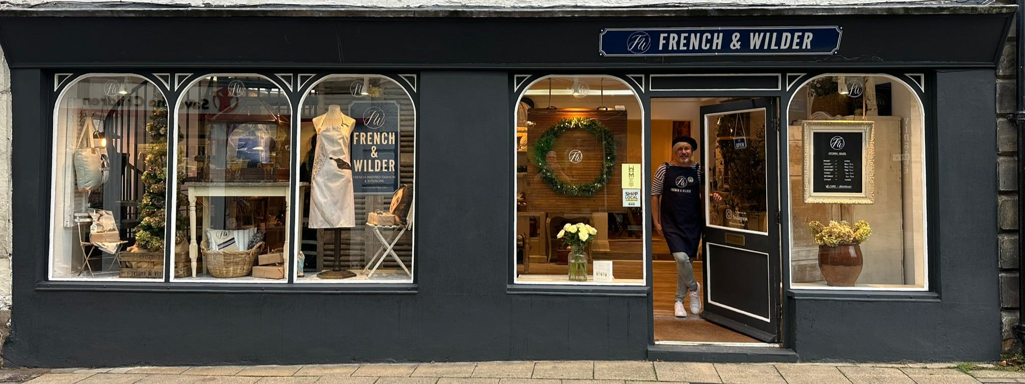 Storefront of French & Wilder with mannequins and products displayed in windows.
