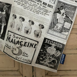 Tea towel featuring a collage of vintage magazine adverts in black and white against a painted wooden surface