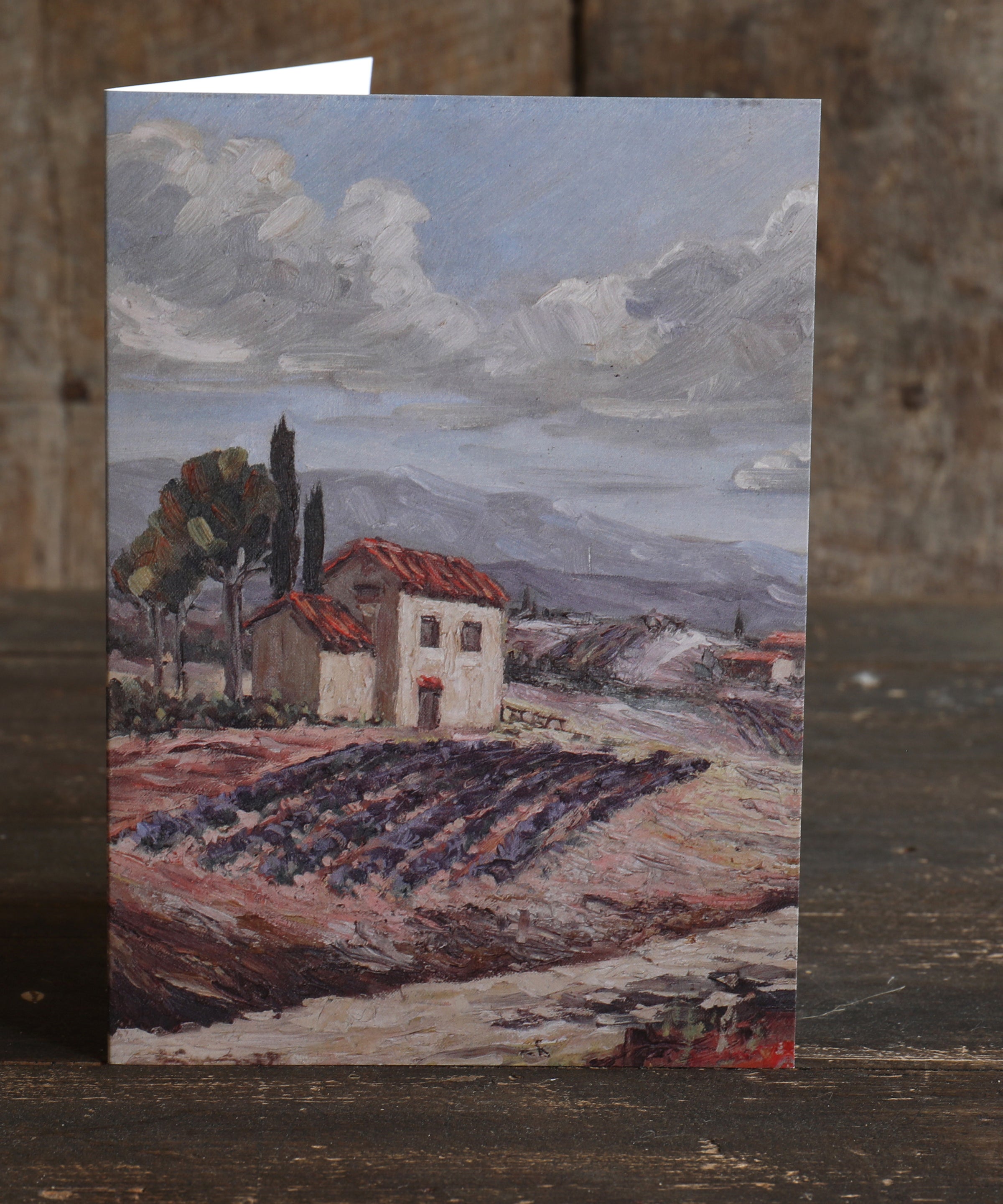 Greetings card featuring a painted Provence landscape with a house and lavender fields on a wooden surface
